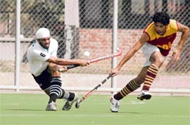 A match in progress between Punjab National Bank and Bharat Petrolium during Guru Govind Singh Gold Cup Hockey Tournament being played at Astroturf Stadium, PAU, in Ludhiana on Sunday.