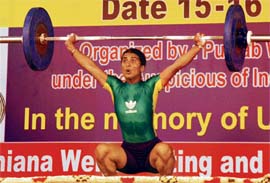 A weightlifter in action during the 17th Men and 12th Women Northern India Weightlifting Championship in Ludhina on Sunday. 