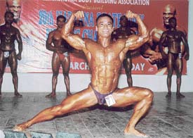 Body builder Anurag Pandey flexes his muscles during the 20th Senior Haryana State Body Building Championship