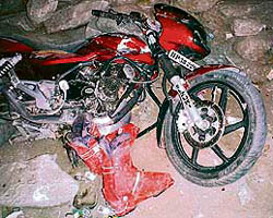A damaged motorcycle (top) and belongings of victims of landslide on the Manali-Rohtang road on Monday.