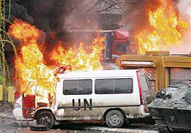 French NATO peacekeeping vehicles burn during clashes with Serb protesters in the ethnically divided city of Kosovska Mitrovica on Monday.