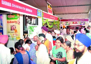 People gather information on herbal products and Ayurvedic medicines during the Arogaya fair in Amritsar.