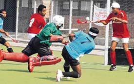 Players from Punjab Police and Indian Oil Corporation teams fight it out during the match held at the Punjab Agricultural University, Ludhiana, on Tuesday.