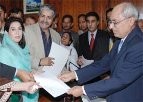 Fahmida Mirza (L), an MP from Pakistan Peoples Party, submits her nomination papers for the post of national assembly speaker at the parliament house in Islamabad