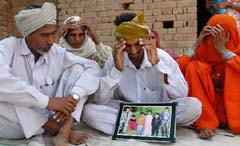 Kulwant Ram (centre), bereaved husband of Jaswinder Kaur who died of food poisoning at Kandwala village near Fazilka. His four children are still undergoing treatment in a hospital. 