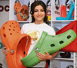 Actress Soha Ali Khan poses with Crocs footwear at its launch in New Delhi on Wednesday. The US-based company said it plans to open company-owned stores here, besides mulling over acquisitions in the country. The company, which entered the Indian market last year, is aiming to have 500 retail points to sell its footwear in India by the end of this year. 