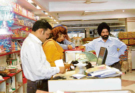 Income tax officials check documents during a raid on a shop in Phase V, Mohali, on Wednesday.