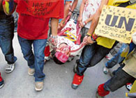 Tibetans conduct a mock funeral during an anti-China demonstration in Dharamsala on Wednesday.