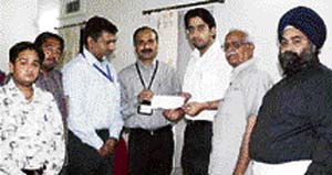 Amit, grandson of deputy speaker of Punjab Vidhan Sabha Sat Pal Gosain, presents a cheque for Rs 5 lakh to interim director of CMCH Dr Abi Thomas in Ludhiana on Wednesday.