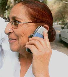 Dalbir Kaur, sister of Sarabjit Singh, talks on her mobile phone at the AICC office in New Delhi