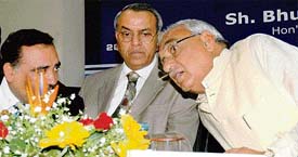 Chief Minister Bhupinder Singh Hooda lends an ear to HSIIDC managing director Rajiv Arora during a meeting with industrialists in Chandigarh on Thursday.