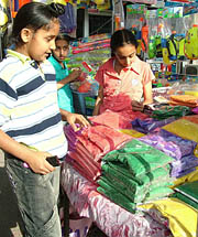 Riot of colours: Kids check out gulals and pichkaris at a stall in Model Town in Jalandhar on Thursday.