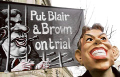 A protester in a Tony Blair mask joins a demonstration outside Downing Street in London on Thursday.