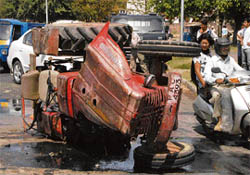 Mangled remains of the tractor that overturned at the road separating sectors 19 and 27 on Friday.