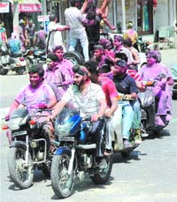 Youngsters take a round of the city celebrating Holi with their friends and passersby in Jalandhar on Friday.