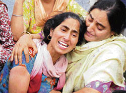 Relatives console the wailing mother of nine-year-old Akash Pandita who died in a road accident on the outskirts of Jammu on Friday.