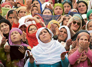 Kashmiri Muslims look at the relic of Prophet Mohammad being displayed during the Eid-e-Milad at the Hazratbal shrine in Srinagar on Friday.