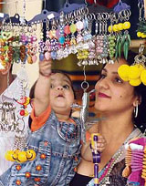 A child eagerly looks at key chains put on sale in a handicraft exhibition at Nehru Sidhant Kendra in Ludhiana.