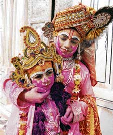Children dressed as Lord Krishna and Radha celebrate Holi at Laxmi Narayan Temple in Amritsar.