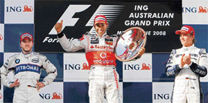 Britains Lewis Hamilton (centre) jubilates on the podium with Nick Heidfeld (left), who was placed second, and Nico Rosberg (right), who finished third, after he won the Australian Formula One Grand Prix in Melbourne on March 16, 2008. Only seven of the total 22 cars completed the race.