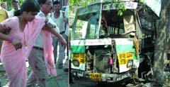 A Blueline bus rammed a tree on Ashoka Road near the Election Commission building, killing a woman and injuring ten in the Capital on Sunday. 