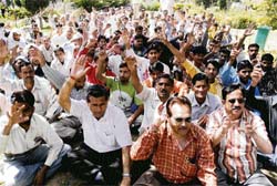 Members of the National Mazdoor Conference protest in Rani park in support of their demands in Jammu on Sunday.