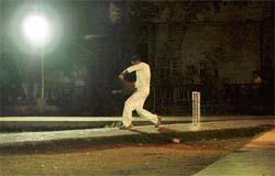 A batsman plays during a night cricket tournament organised in Ludhiana on Saturday