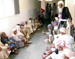 Patients wait for their turn for intraocular lens implant during an eye camp in Ahmedgarh on Saturday.