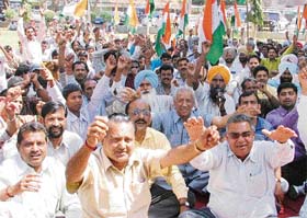 Activists of the Indian National Trade Union Congress stage a dharna outside the deputy commissioners office in Ludhiana