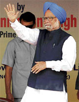 Prime Minister Manmohan Singh waves to the crowd prior to laying the foundation stone of the 1500 MW Pragati Phase-111 Gas Power Project in Delhi on Monday.