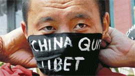 A Tibetan monk in exile ties a headband ahead of an anti-Chinese demonstration near the United Nations headquarters in Kathmandu on Monday.