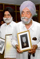 G.S. Sandhu (left), chairman, Majha Ex-Serviceman Human Rights Front, with police medal awardee Joginder Singh Pannu in Chandigarh on Tuesday.