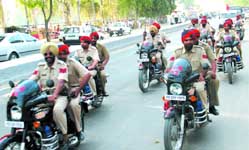 Policemen carrying out flag march on Bathinda-Goniana road