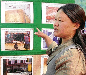 A member of the Tibetan Solidarity Committee educates people about the killings in Lhasa (Tibet) by the Chinese Army through an exhibition of photographs at Shimla on Wednesday.