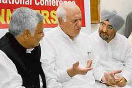 Former chief minister Farooq Abdullah discusses a point with party leaders during the first anniversary of Jumbo Times, a weekly newspaper, in Jammu on Wednesday. 