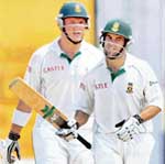 South Africas Neil McKenzie (R) celebrates on completing his fifty as captain Graeme Smith looks on during the first day of the first Test at the Chepauk Stadium in Chennai 
