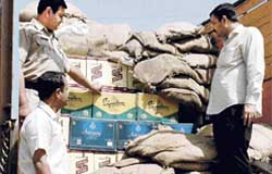 Excise and taxation officials with cases of liquor seized in Panchkula on Thursday