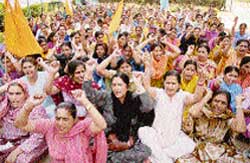Anganwadi workers lodge a protest outside the divisional commissioners office in Jammu