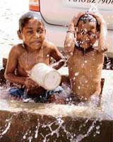 Street children enjoy a bath in the sun in Ludhiana on Thursday.