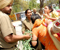 Cops drag the slogan raising woman anganwari workers out of the Chief Minister Prakash Singh Badals seminar in Bathinda on Thursday.