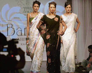 Models display creations by Pakistani designers at a fashion show in Lahore on Friday. Scores of Pakistan fashion designers participated in the show organised by Chamber of Commerce and Industries to boost cultural values. 