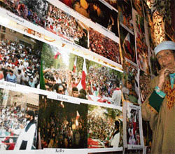 A Kashmiri woman looks at pictures during an exhibition at Sir Mohammad Iqbal convention centre in Srinagar on Saturday.