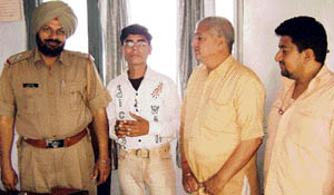 Office-bearers of the R.S. Football Club along with the player at the Ahmedgarh police station on Saturday.