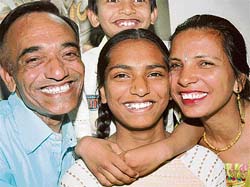 Shivangi, who topped the Class VIII examination, with her parents at her house in Panchkula on Sunday