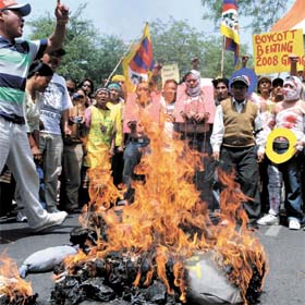 Tibetan activists burn the effigy of Chinese President Hu Jintao during a protest at Jantar Mantar in the Capital