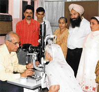 An eye specialist examines patients at a camp organised by Nihal Singh Pahwa Charitable Hospital in Ludhiana on Sunday.