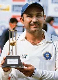 Virender Sehwag poses with the Man of the Match trophy at the conclusion of the first Test against South Africa in Chennai