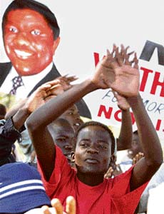 Supporters of Zimbabwes opposition Movement for Democratic Change celebrate the preliminary constituency election results in Harares Budiriro suburb