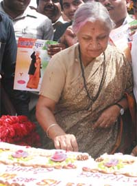 Chief Minister Sheila Dikshit cuts her birthday cake at her residence in the Capital
