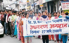 Computer teachers take out a candlelight procession in Hamirpur